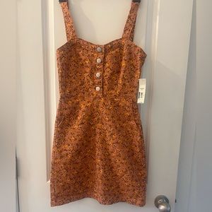 Cute Mini dress with a zipper in the back and buttons in the front. Size xs.